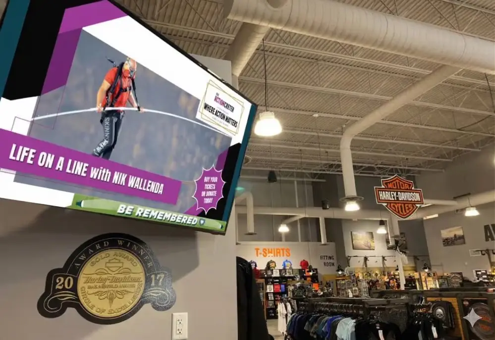 Digital billboard displaying advertising content inside Harley-Davidson retail store